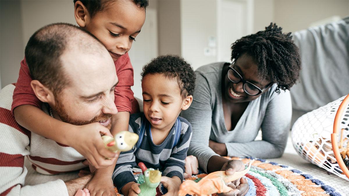 young family playing on floor together