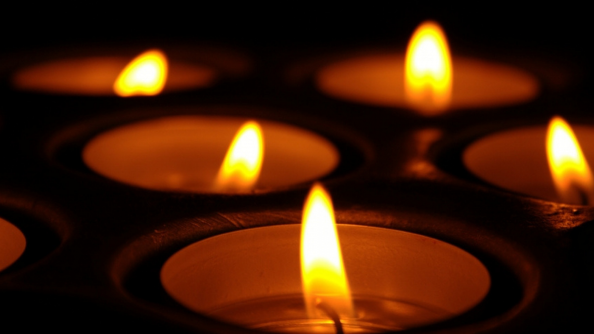 Lit tea light candles in a dark area