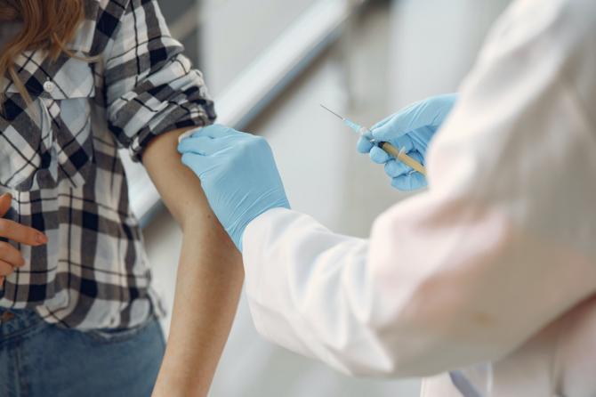 person with sleeve rolled up receiving vaccination