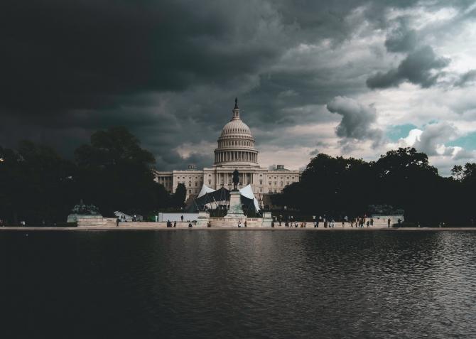 view from reflecting pool toward US Capitol building in stormy weather