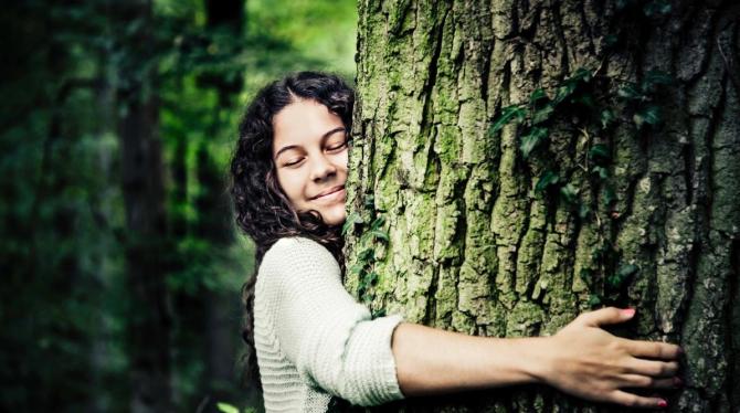 woman hugging tree