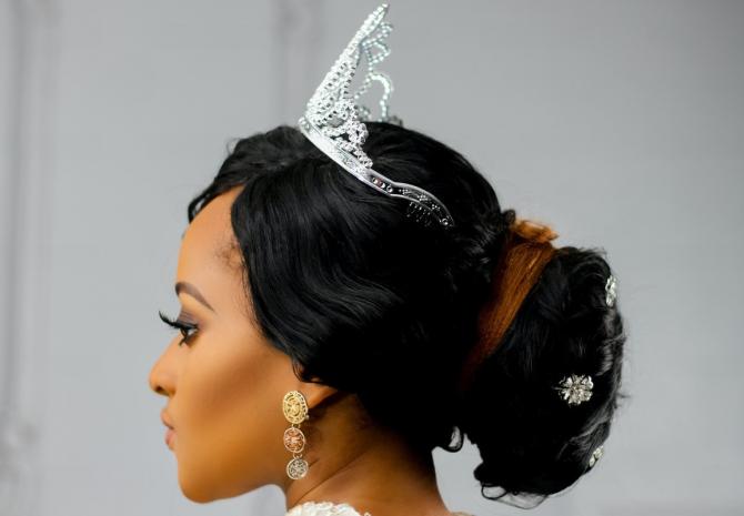 profile view of woman in tiara with resolute expression