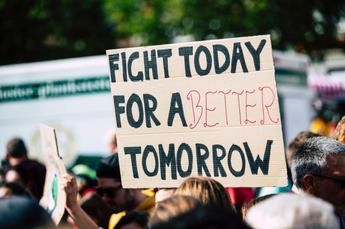 Sign at public protest reading "Fight today for a better tomorrow"
