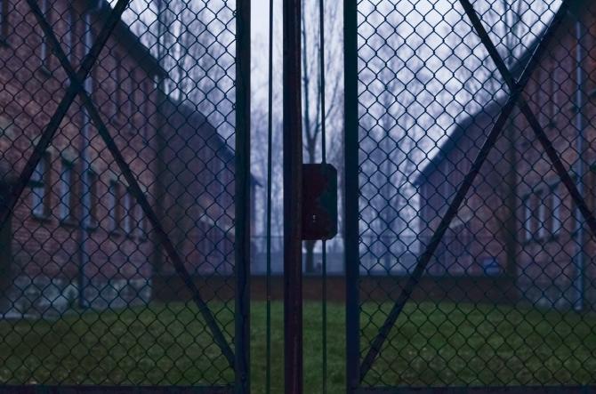 Barracks viewed through iron fence