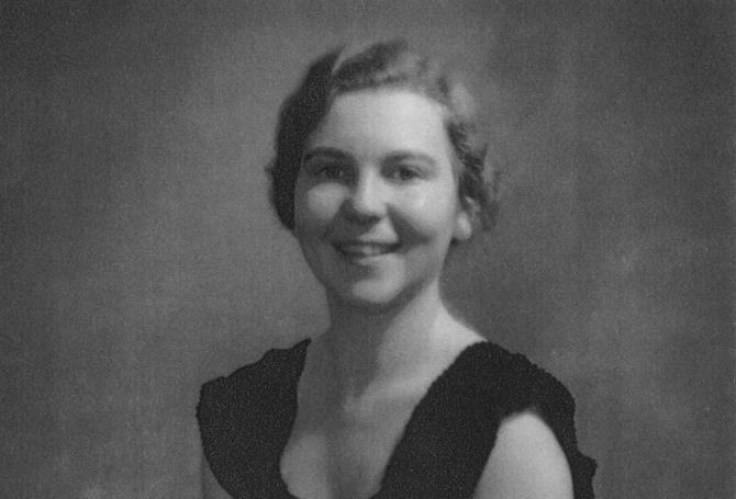 black-and-white photo of teenage girl with black dress and short wavy hair