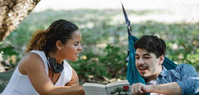 woman and man discussing a passage from a book