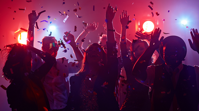 Partially silhouetted celebrants dancing