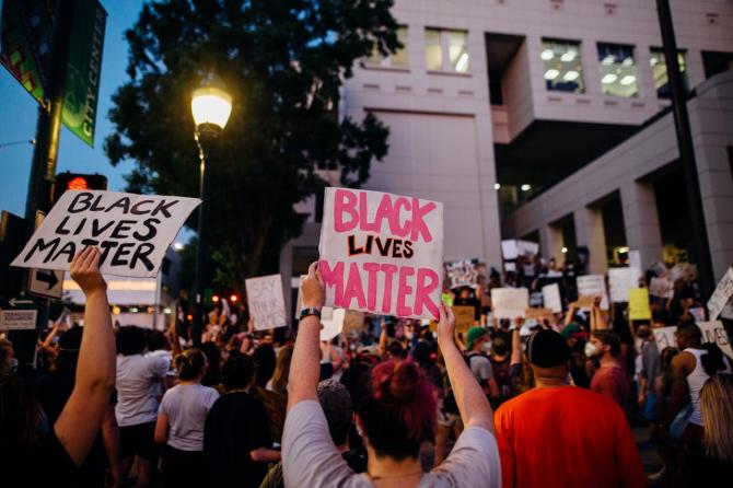 Crowd holding Black Lives Matter signs