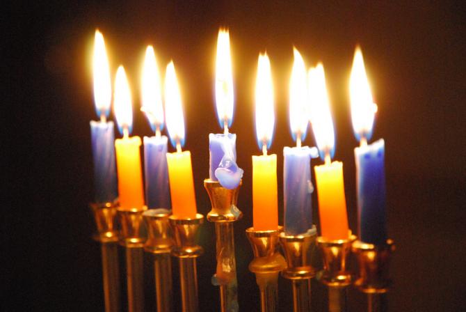 hanukkah menorah full of blue and gold candles