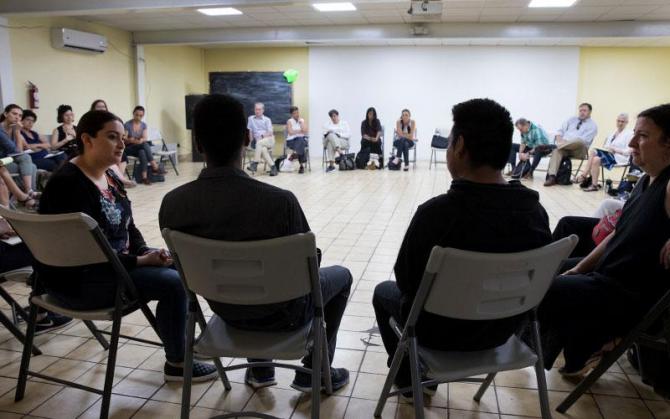 Two migrant men, deported from the US within the previous 24 hours, share their story with the group at the Centro Scalabrini Casa del Migrante in Tijuana, Mexico