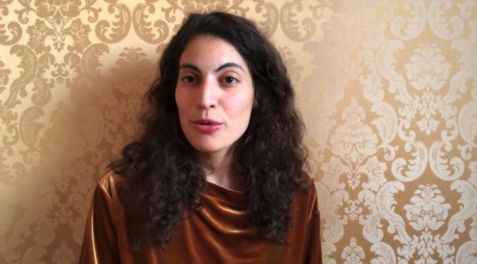 Hadar Cohen (woman with dark curly hair) speaking