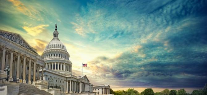 United States Capitol Building at sunrise with clouds in the sky