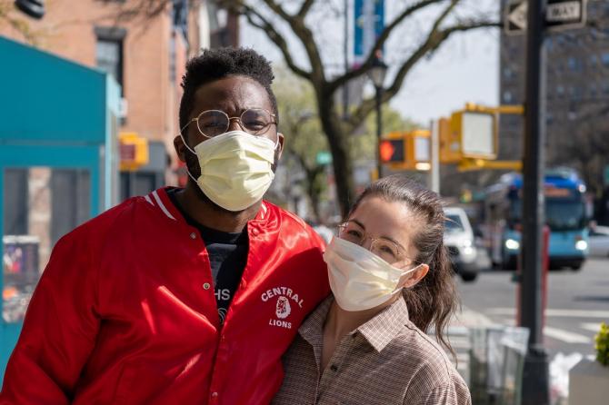 Masked man and woman arm in arm