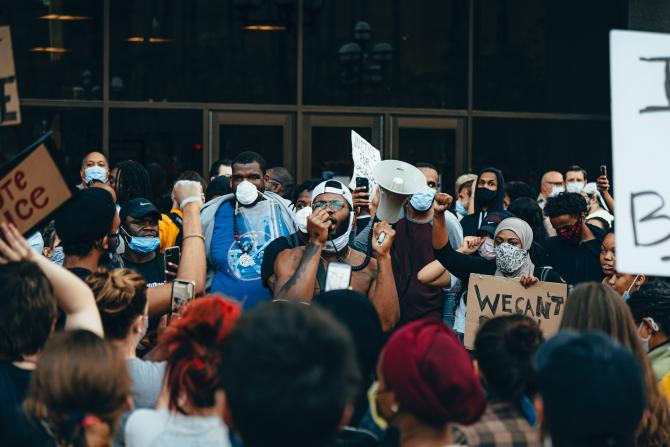 Black Lives Matter protest with man speaking into PA amplifier microphone