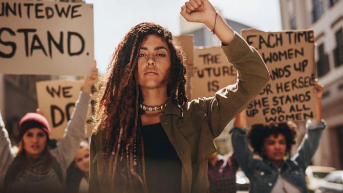 Person with fist up leading protest