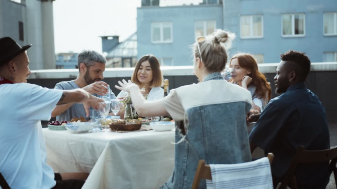 Multicultural dinner on a building roof