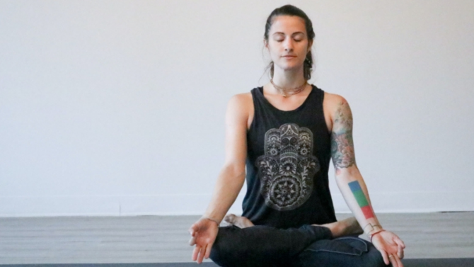 Person meditating on a yoga mat