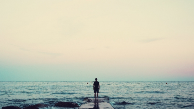 Person looking out onto a large body of water