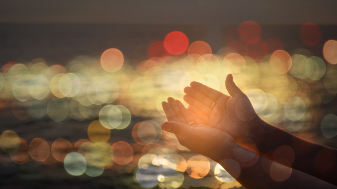 Hands outstretched against an abstract background