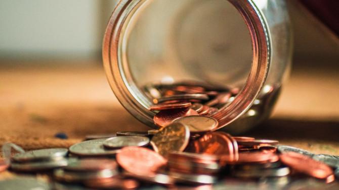 Overturned jar of coins