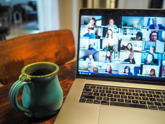 Laptop displaying multi-party video conference call 