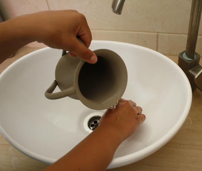 ritual handwashing with pitcher and basin