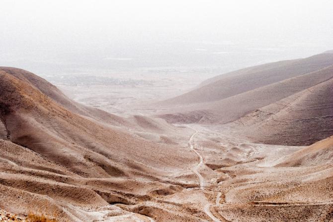 desert road in valley between mountains