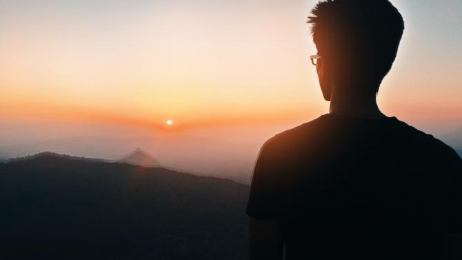 Silhouette of man gazing into sunset
