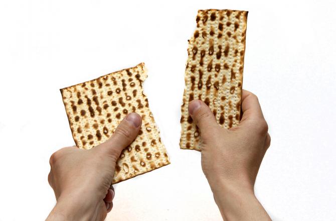 Matzah being broken in half