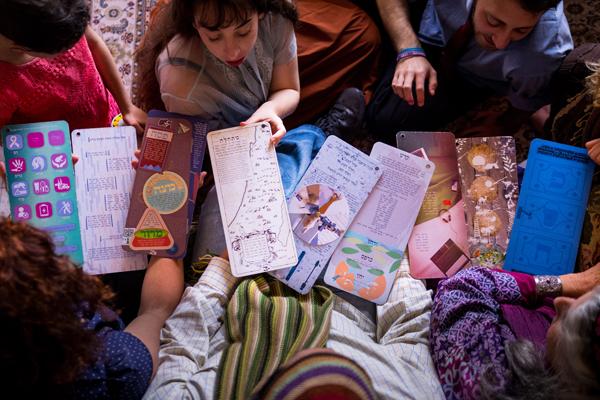 Overhead view of children with hand-drawn Passover haggadahs