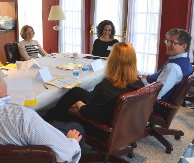 Tresa Grauer seated at table with congregational leaders 