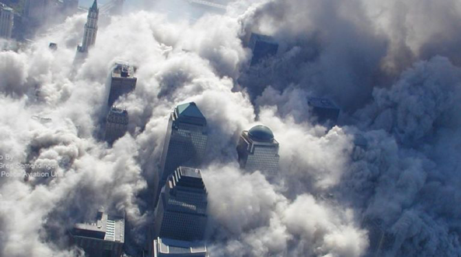 Billowing cloud of dust and debris envelops lower Manhattan as the South Tower collapses