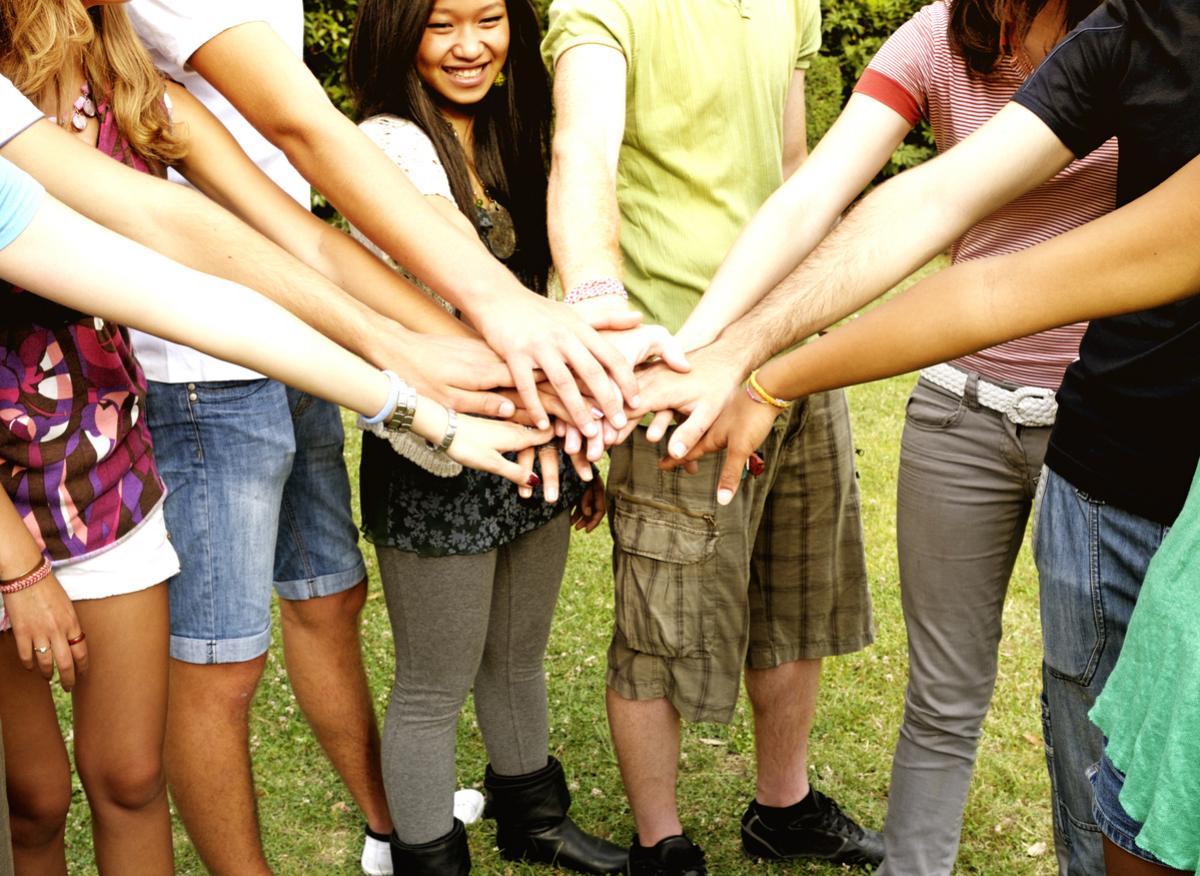 Friends stacking hands