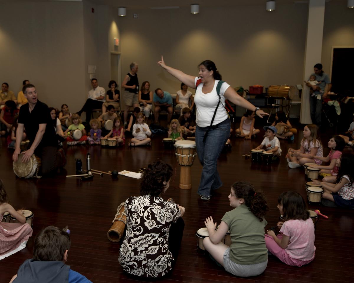 Kids gathered around music teacher