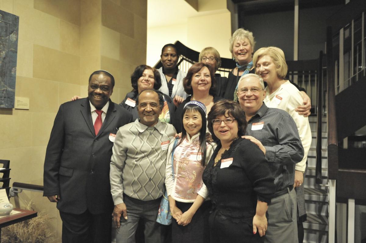 A multiracial, multigenerational group of Jews gathered for a group photo