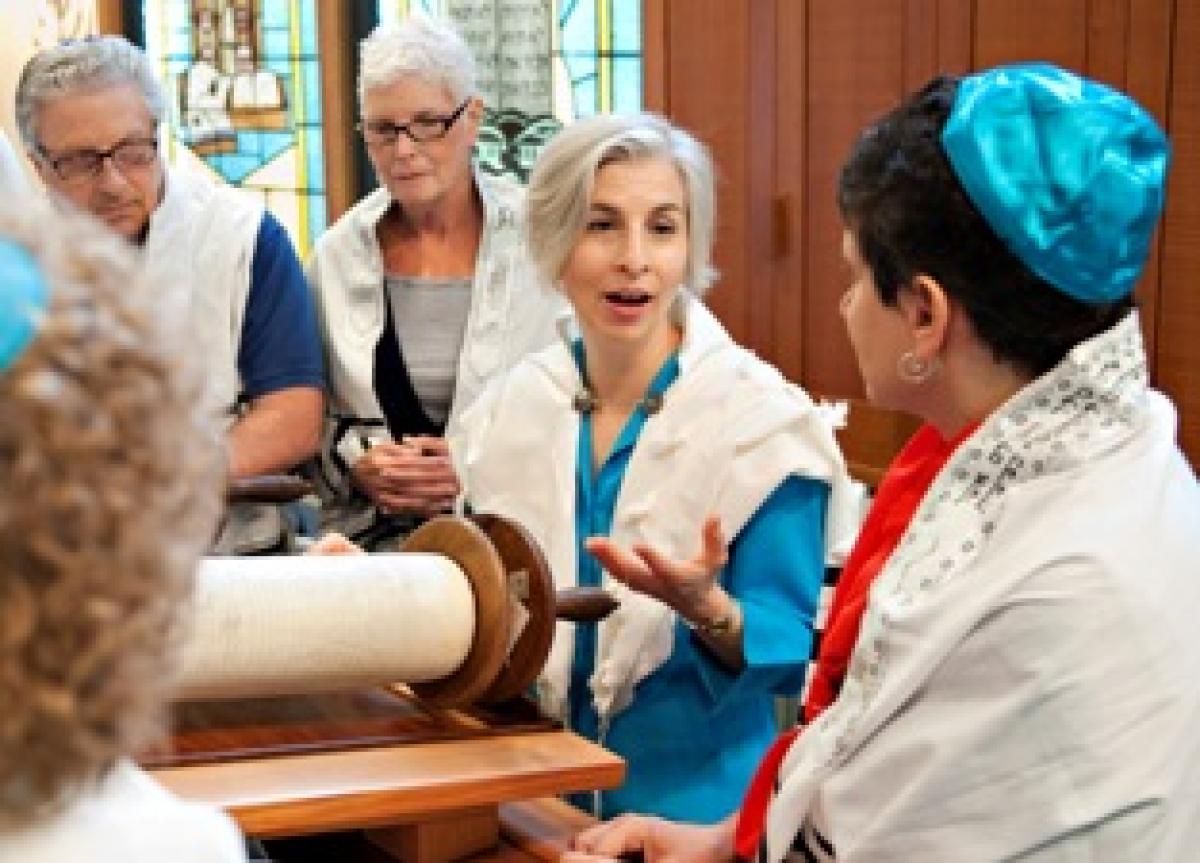 Rabbi Jen Feldman speaking with congregation members