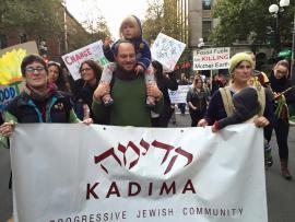 Marchers holding a sign for Kadima Reconstructionist Congregation