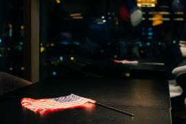 American flag lying on a dark glass table