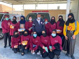 volunteers in face masks posing for a group photo