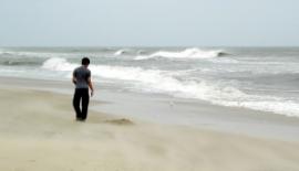 Young person walking on beach