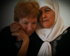 Two women comfort one another - one Israeli, one Palestinian