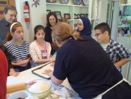 Children from Syria sponsored by Congregation Dorshei Emet learn to make pizza
