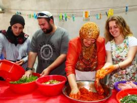 mixed group of Arab and Jewish men and women cooking together