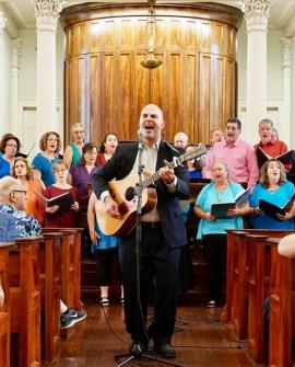 Bet Haverim chorus led by songleading with guitar
