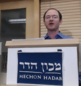 Eli Kaunfer at podium labeled Mechon Hadar
