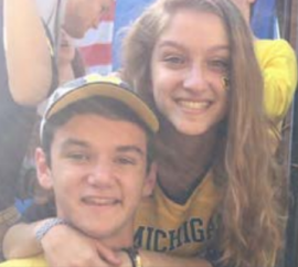 Teenage girl and younger brother smiling for portrait