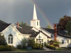 Photo of synagogue with rainbow in background