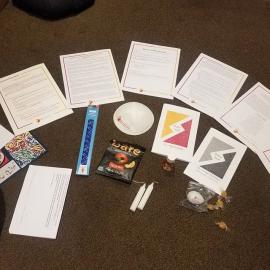 Spread out contents of Rosh Hashanah bag - written texts, candles, honey candies, apple snacks