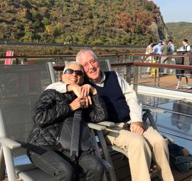 Rabbi Sheila Peltz Weinberg with husband Maynard Seider, seated with lake and mountains in the background