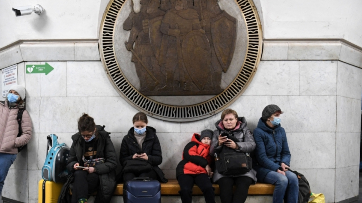 Ukranian people waiting on a bench for news